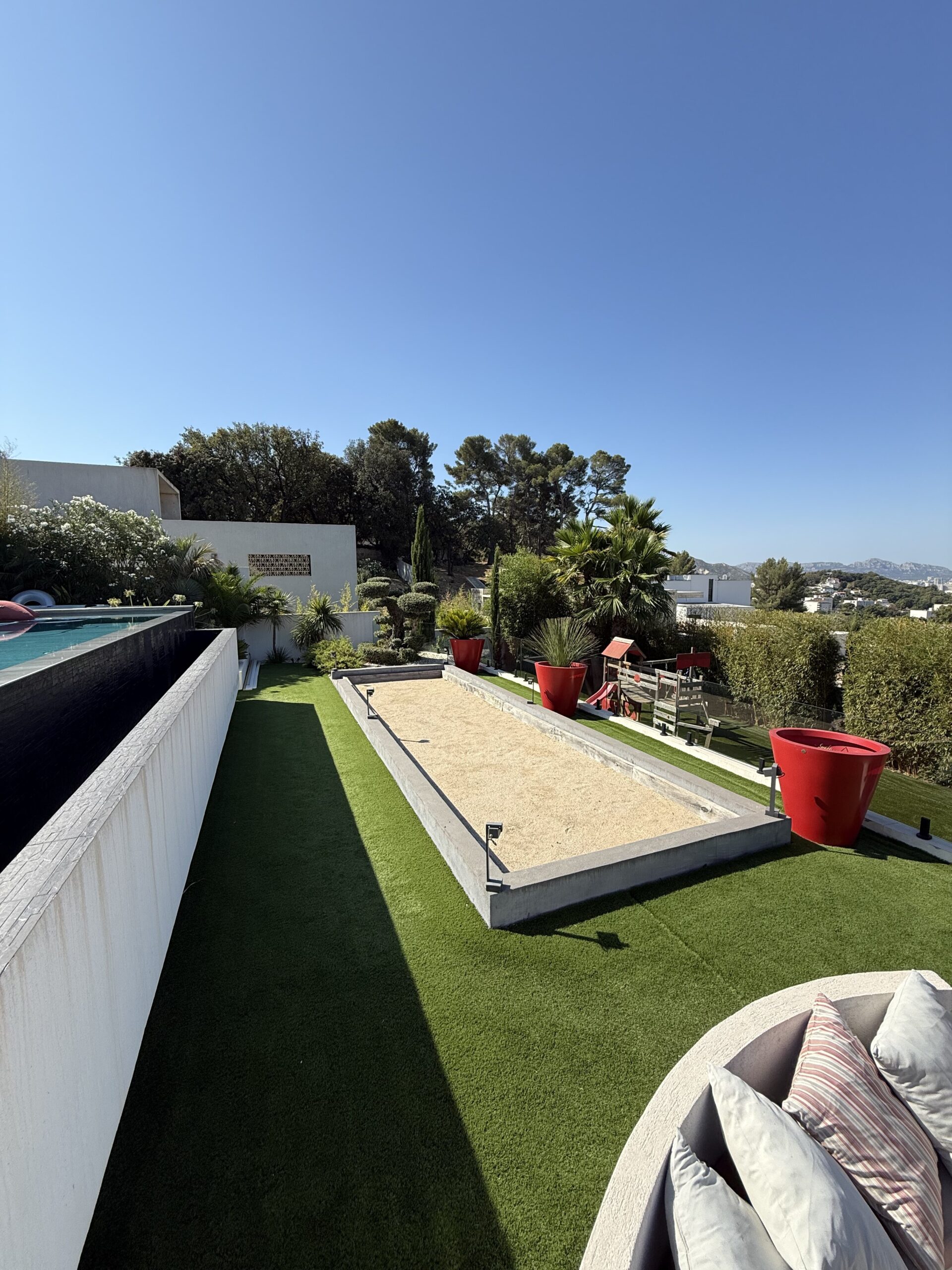 Création de terrain de pétanque dans le jardin, aménagement extérieur, convivial avec le gazon, synthétique et espaces de loisirs.